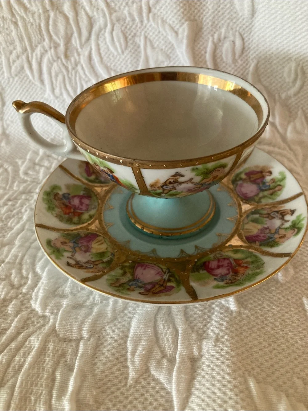 Gold-Trimmed Blue and White Porcelain Teacup and Saucer